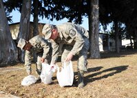 INCIRLIK AIR BASE, Turkey—Maj. Mishaun Smith, 39th Comptroller Squadron commander, and Master Sgt. Joshua Ockens, 39th CPTS quality assurance manager, pick up trash Feb. 7, 2014, at Incirlik Air Base. Each unit is assigned an area of responsibility, in a team effort to better the appearance of the Incirlik community. This new initiative is designed to keep the base clean and get Airmen involved with taking pride in Incirlik. (U.S. Air Force photo by Staff Sgt. Veronica Pierce/Released) 