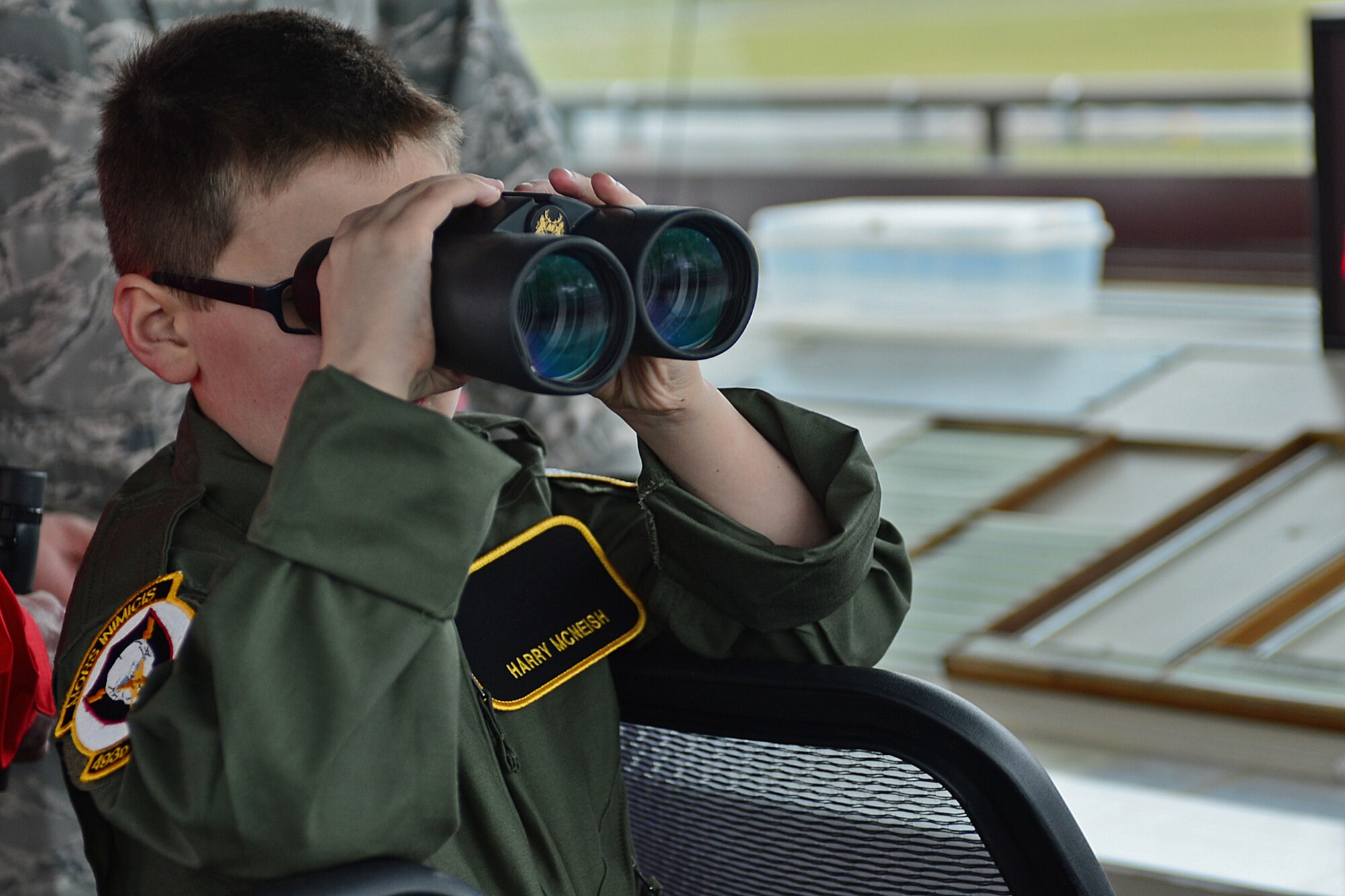 Harry McNeish, 9, watches from the aircraft control tower during a “Pilot for the Day” event at Royal Air Force Lakenheath, England, Feb. 5, 2014. The program started at RAF Lakenheath in March 2012, to assist children throughout local communities who are fighting life-threatening illness or conditions by providing a day of fun and allowing for a break from the routine doctor and hospital visits. (U.S. Air Force photo by Airman 1st Class Dana J. Butler/Released)
