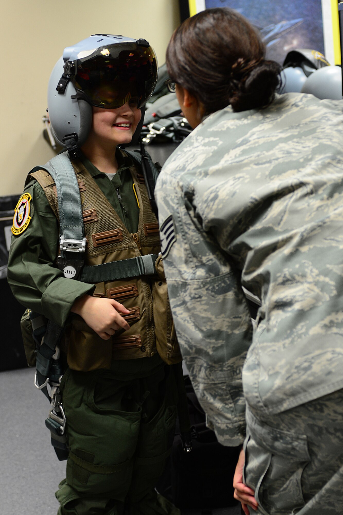 Harry McNeish, 9, tries on an F-15 fighter pilot helmet during a “Pilot for the Day” event at Royal Air Force Lakenheath, England, Feb. 5, 2014. The program started at RAF Lakenheath in March 2012, to assist children throughout local communities who are fighting life-threatening illness or conditions by providing a day of fun and allowing for a break from the routine doctor and hospital visits. (U.S. Air Force photo by Airman 1st Class Dana J. Butler/Released)