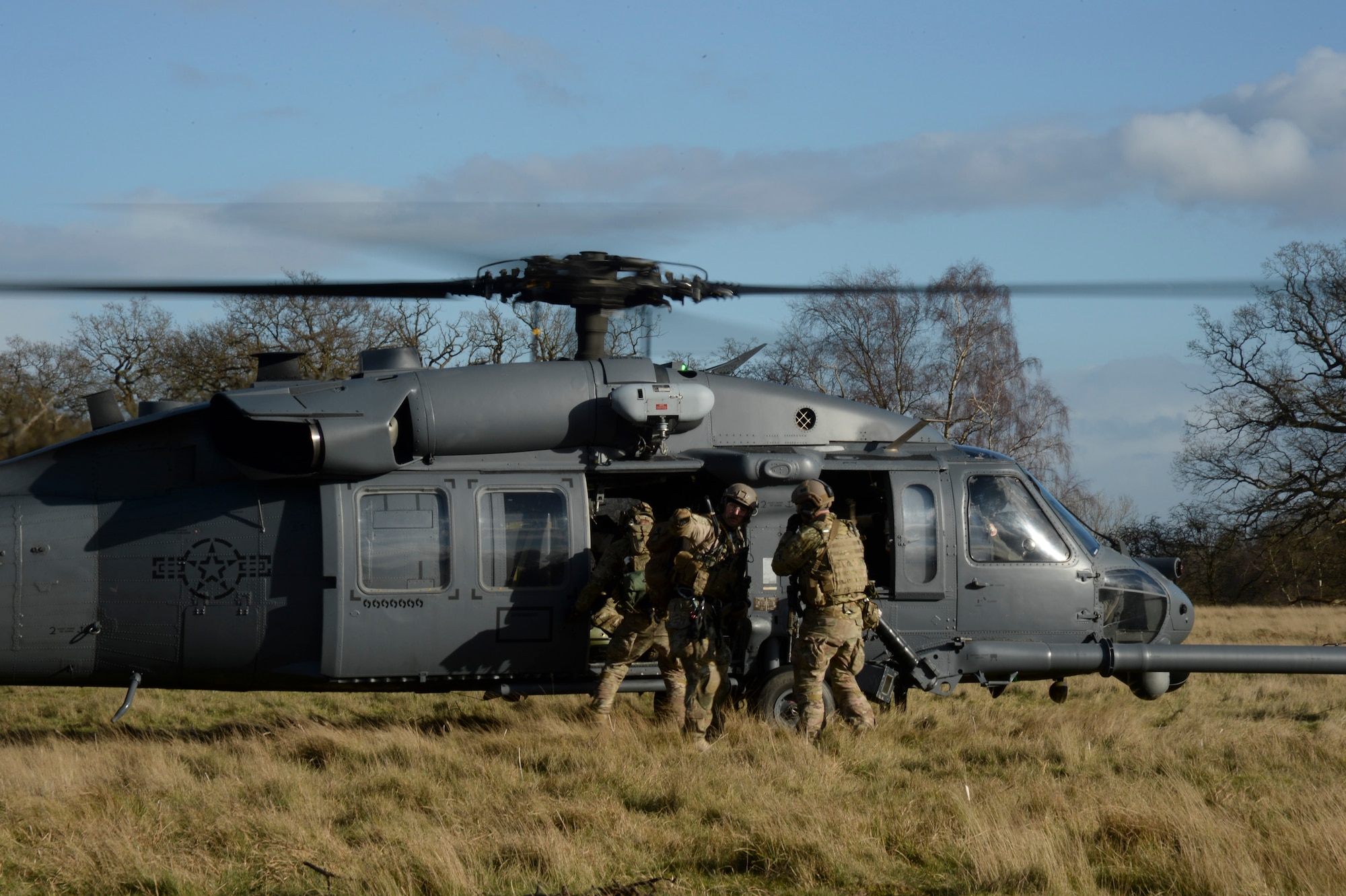 Pararescue specialists from the 56th Rescue Squadron load victims into an HH-60G Pave Hawk helicopter at the Stanford Training Area, England, Feb. 6, 2014. Airmen participated in four days of training exercises in support of the Air Force’s combat search and rescue mission. (U.S. Air Force photo by Airman 1st Class Nigel Sandridge/Released)
