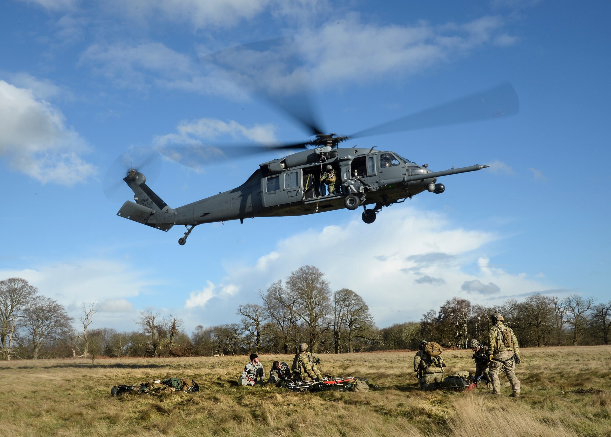 Pararescue specialists from the 56th Rescue Squadron load mock victims into an HH-60G Pave Hawk helicopter at the Stanford Training Area, England, Feb. 6, 2014. Airmen participated in four days of 56th Rescue Squadron training exercises in support of the Air Force’s combat search and rescue mission. (U.S. Air Force photo by Airman 1st Class Nigel Sandridge/Released)