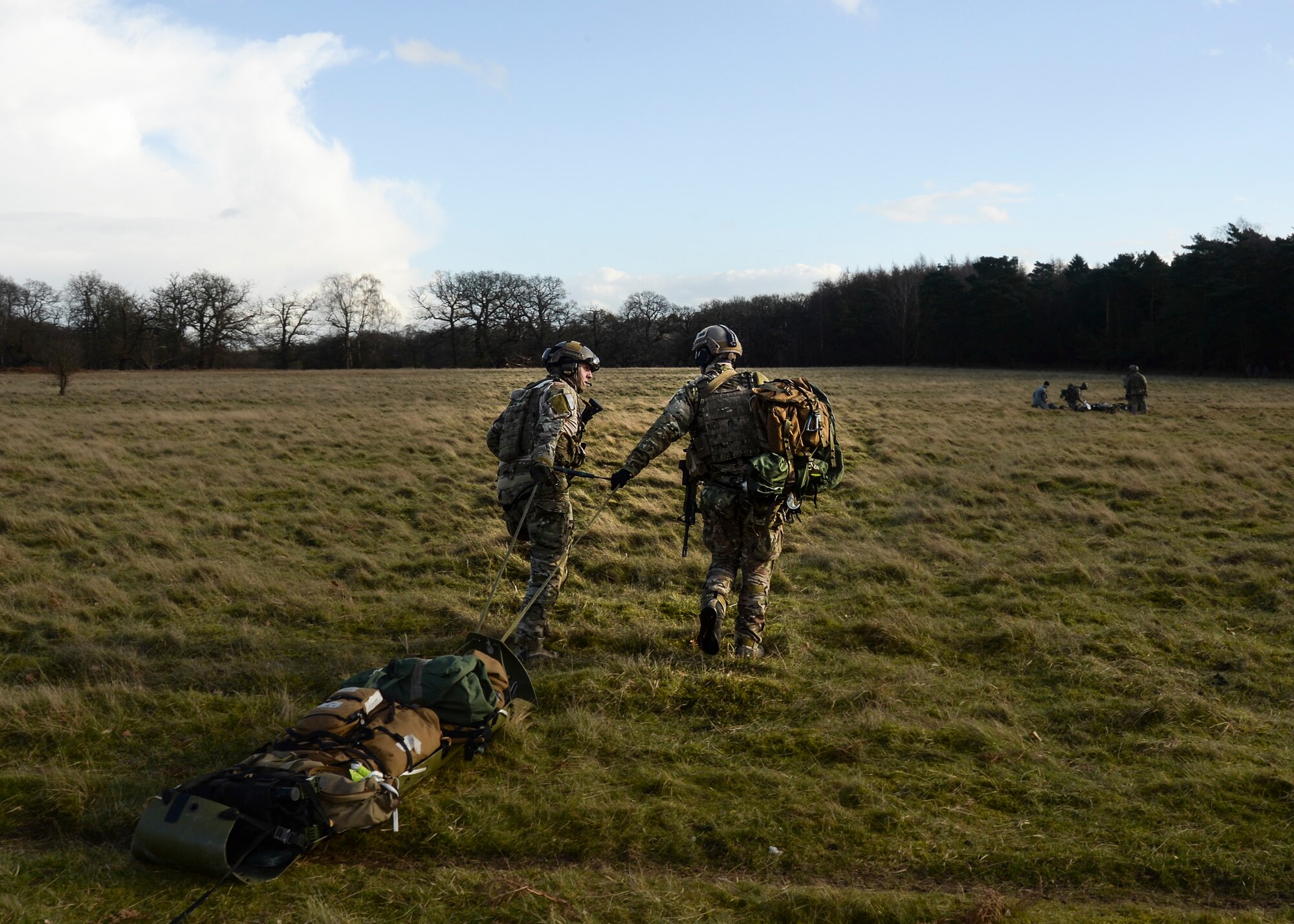 Pararescue specialists from the 56th Rescue Squadron take medical equipment and mock victims to a pick-up location at the Stanford Training Area, England, Feb. 6, 2014. Airmen participated in four days of training exercises in support of the Air Force’s combat search and rescue mission. (U.S. Air Force photo by Airman 1st Class Nigel Sandridge/Released)