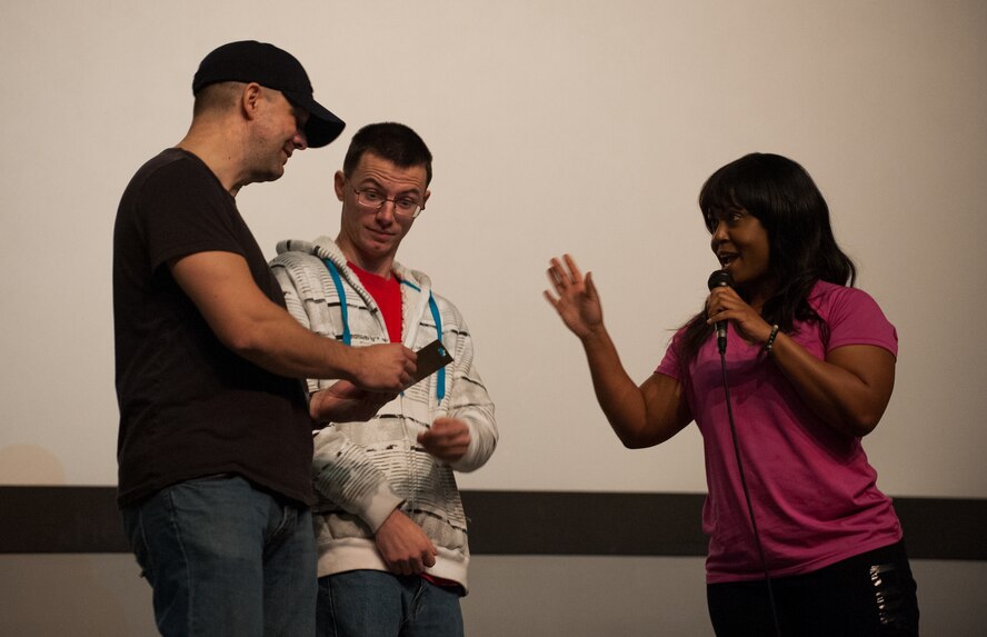 Master Sgt. Keith Vershay, 8th Fighter Wing Judge Advocate, and Airman Alfred Willard, 8th Operations Support Squadron, receive a gift card for coming in first place at the Showtime at Kunsan Apollo event at Kunsan Air Base, Republic of Korea, Feb. 9, 2014. The talent show was the kick-off event for Kunsan's National African American History Month observance. (U.S. Air Force photo by Staff Sgt. Clayton Lenhardt/Released)