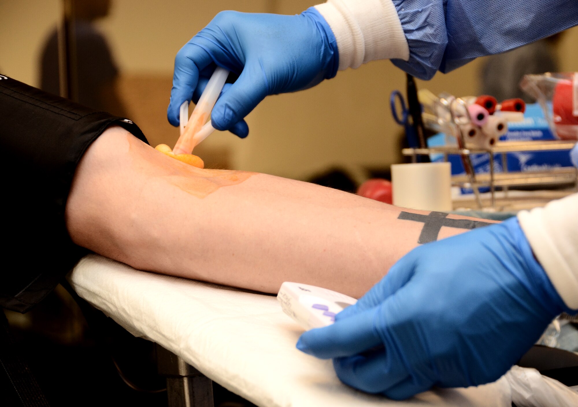 A U.S. Naval Hospital Guam phlebotomist sanitizes a donor’s arm before taking his blood during the 36th Contracting Squadron-sponsored blood drive Jan. 27, 2014, on Andersen Air Force Base, Guam. The Armed Services Blood Program estimates one 500 milliliter donation has the potential to save up to three lives. (U.S. Air Force photo by Airman 1st Class Amanda Morris/Released)