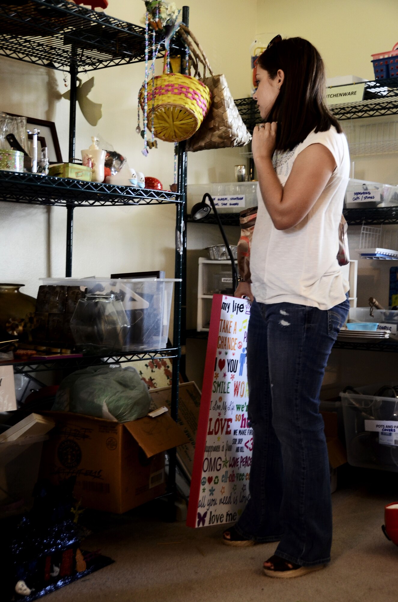 An Air Force spouse looks through goods at the Airman’s Attic Jan. 8, 2014, on Andersen Air Force Base, Guam. The Airman’s Attic is located in military family housing at 1558 Bamboo Lane and is open 10 a.m. to noon every Wednesday for ranks E-1 to E-5 and 10 a.m. to noon every Friday for all ranks.  (U.S. Air Force photo by Airman 1st Class Amanda Morris/Released)