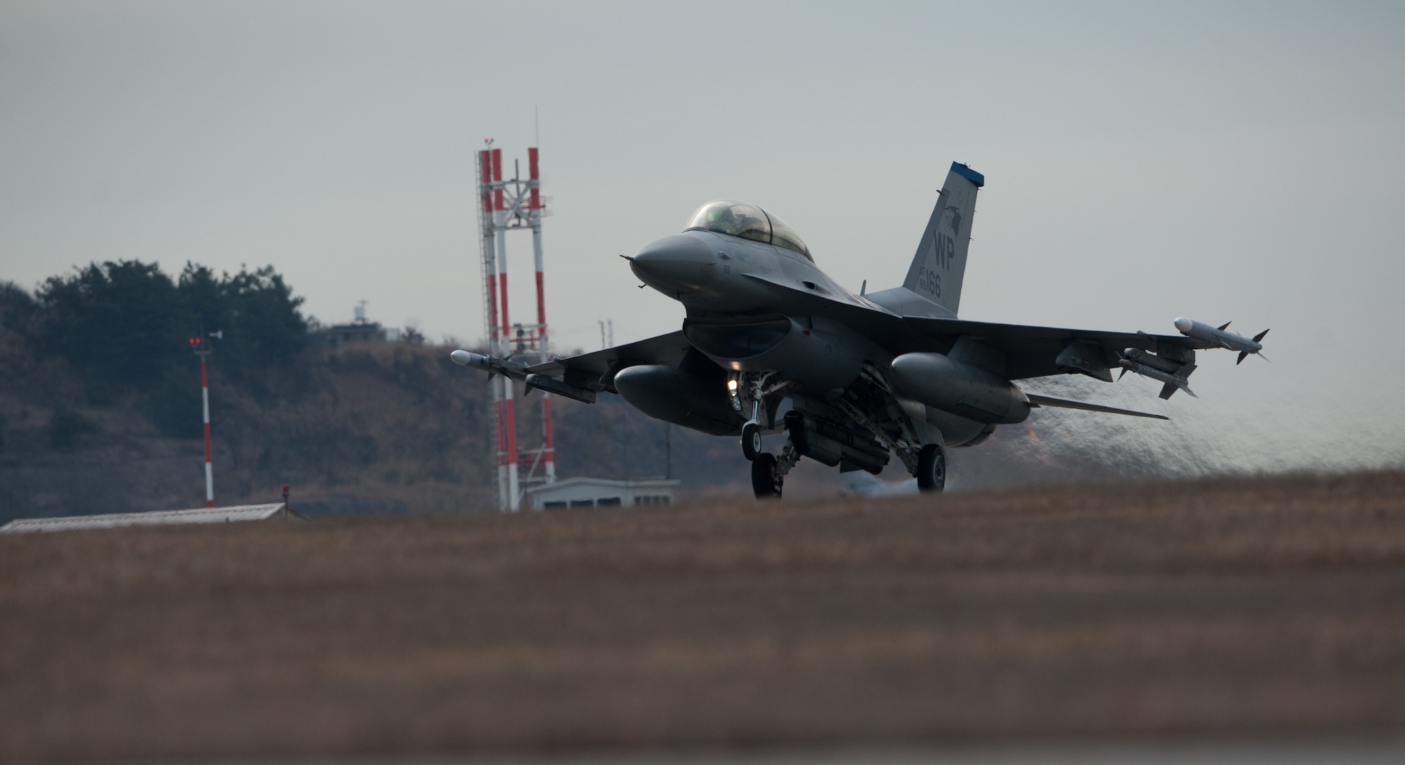 A 35th Fighter Squadron F-16 Fighting Falcon takes off for a sortie during Beverly Midnight 14-01 at Kunsan Air Base, Republic of Korea, Feb. 7, 2014. BM 14-01 tested the Wolf Pack’s ability to react to a surprise attack and continue launching aircraft. (U.S. Air Force photos by Senior Airman Armando A. Schwier-Morales/Released)