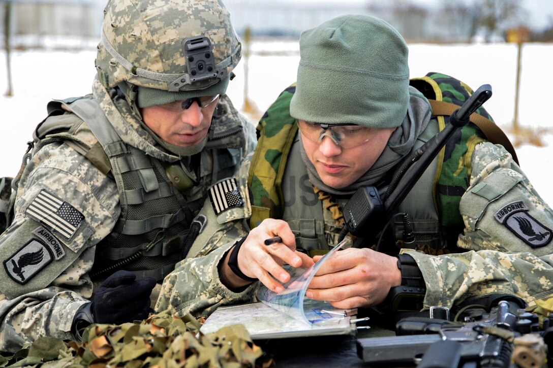 U.S. Army 1st Lt. Andrew Martin, right, and U.S. Army Sgt. Anthony Tapia, use a map to prepare for a maneuver exercise at the 7th Army Joint Multinational Training Command's Grafenwoehr Training Area, Germany, Feb. 6, 2014. Martin and Tapia, paratroopers, are assigned to Company A, 91st Cavalry Regiment, 173rd Infantry Brigade Combat Team. 