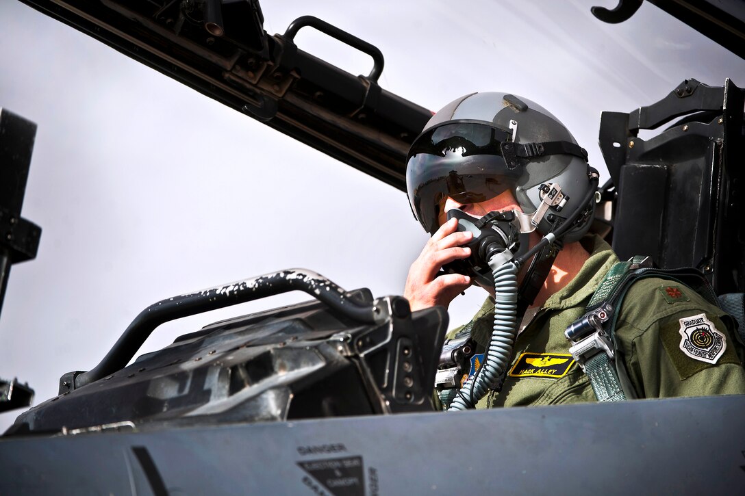 U.S. Air Force Maj. Christopher Alley conducts preflight checks during exercise Red Flag 14-1 on Nellis Air Force Base, Nev., Jan. 30, 2014. Alley, a weapons systems officer, is assigned to the 391st Fighter Squadron F-15E Strike Eagle. Red Flag allows pilots to train in real-time war scenarios and gives ground crews an opportunity to test readiness capabilities.