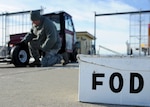 Master Sgt. Lance Stephenson, 28th Bomb Wing Foreign Object Debris program manager, inspects the FOD Mule prior to driving it onto the flight line at Ellsworth Air Force Base, S.D., Jan. 31, 2014. The FOD program is designed to eliminate any foreign objects from the flightline that can cause damage to aircraft and equipment. (U.S. Air Force photo by Senior Airman Anania Tekurio/Released)