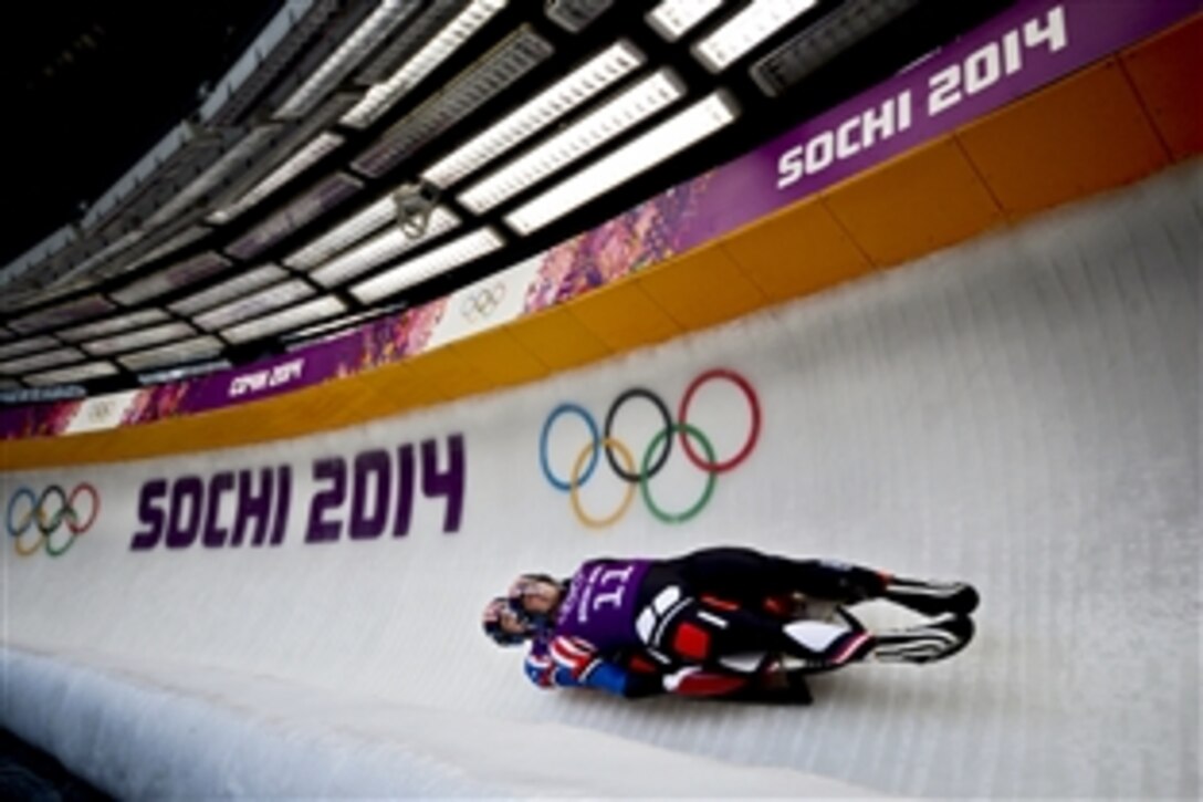 U.S. Army Sgts. Matt Mortensen, top, and Preston Griffall, both U.S. Army World Class Athlete Program soldiers,  race at 80 mph on a run of 51.660 seconds during Olympic luge doubles training at Sanki Sliding Centre in Krasnaya Polyana, Russia, Feb. 10, 2014. Mortensen is a New York National Guardsman and Griffal is a Utah National Guardsman. 