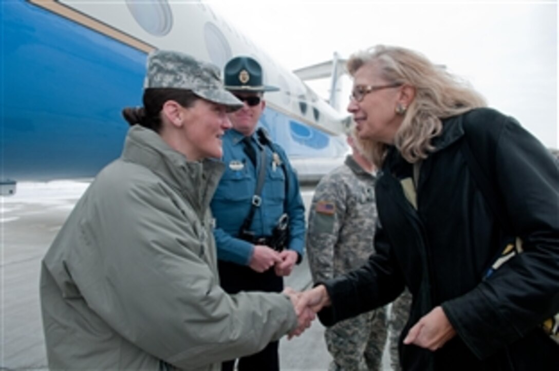 A soldier greets Acting Deputy Defense Secretary Christine H. Fox upon her arrival at Manhattan Regional Airport, Manhattan, Kan., near Fort Riley, Feb. 10, 2014. Army Maj. Gen. Paul E. Funk II, 1st Infantry Division and Fort Riley commanding general, gave Fox a tour of the tactical operations center on the base, where she observed soldiers assigned to the 2nd Armored Brigade Combat Team, 1st Infantry Division during training.