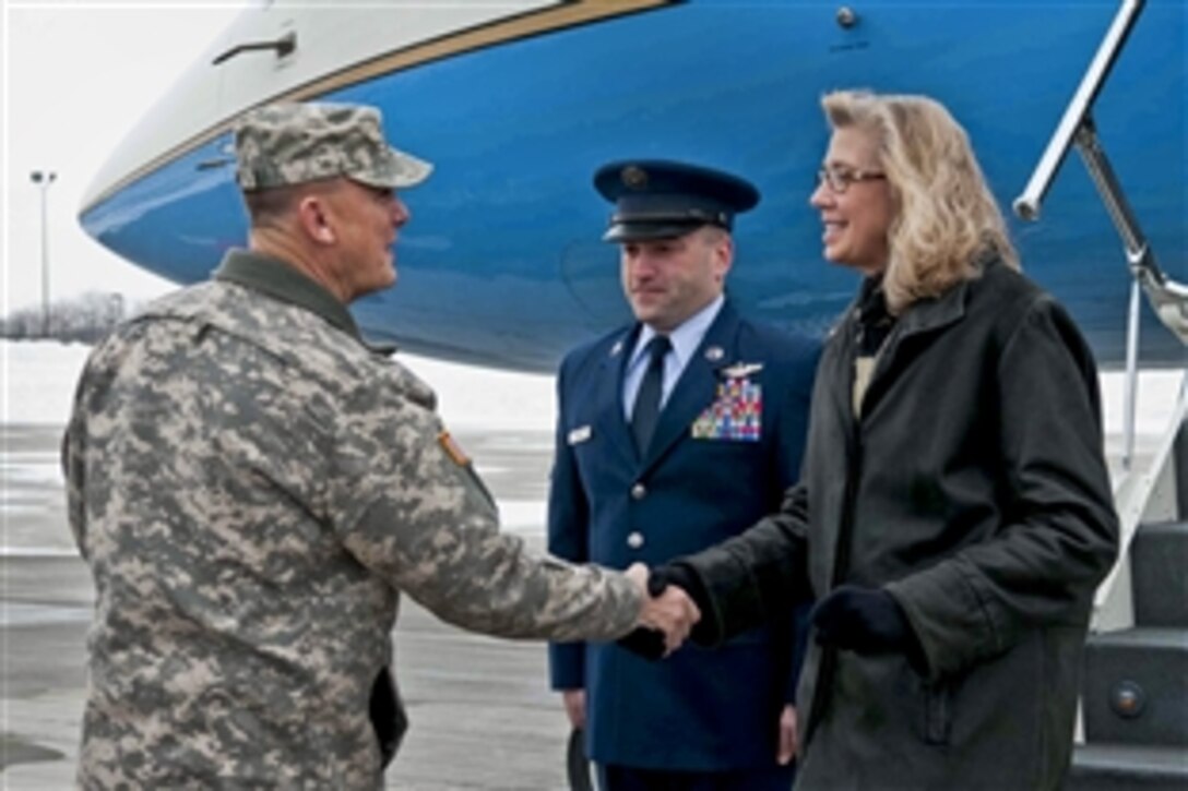 Army Maj. Gen. Paul E. Funk II, the commanding general for the 1st Infantry Division and Fort Riley, Kan., welcomes Acting Deputy Defense Secretary Christine H. Fox as she arrives at Manhattan Regional Airport, Feb. 10, 2014, for a tour of the post and its training facilities. Fox and her staff visited a tactical operations center to observe how soldiers train and use technology.