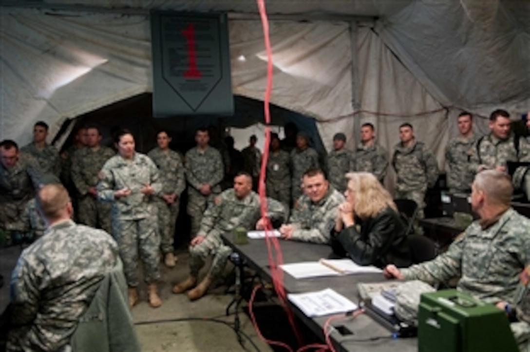 Acting Deputy Defense Secretary Christine H. Fox listens as she observes training on Fort Riley, Kan., Feb. 10, 2014.