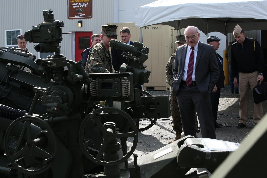 Dennis McGinn, the assistant secretary of the Navy for energy, installations and environments, is briefed on the Medium Tactical Vehicle Replacement Auxiliary Power Unit, a new generator in development, during a tour of Marine Corps Base Quantico on Feb. 6, 2014. The MTVR-APU is attached to the cab of a 7-ton truck and can be used to power radio, navigation and weapon systems like the M777A2 Howitzer.