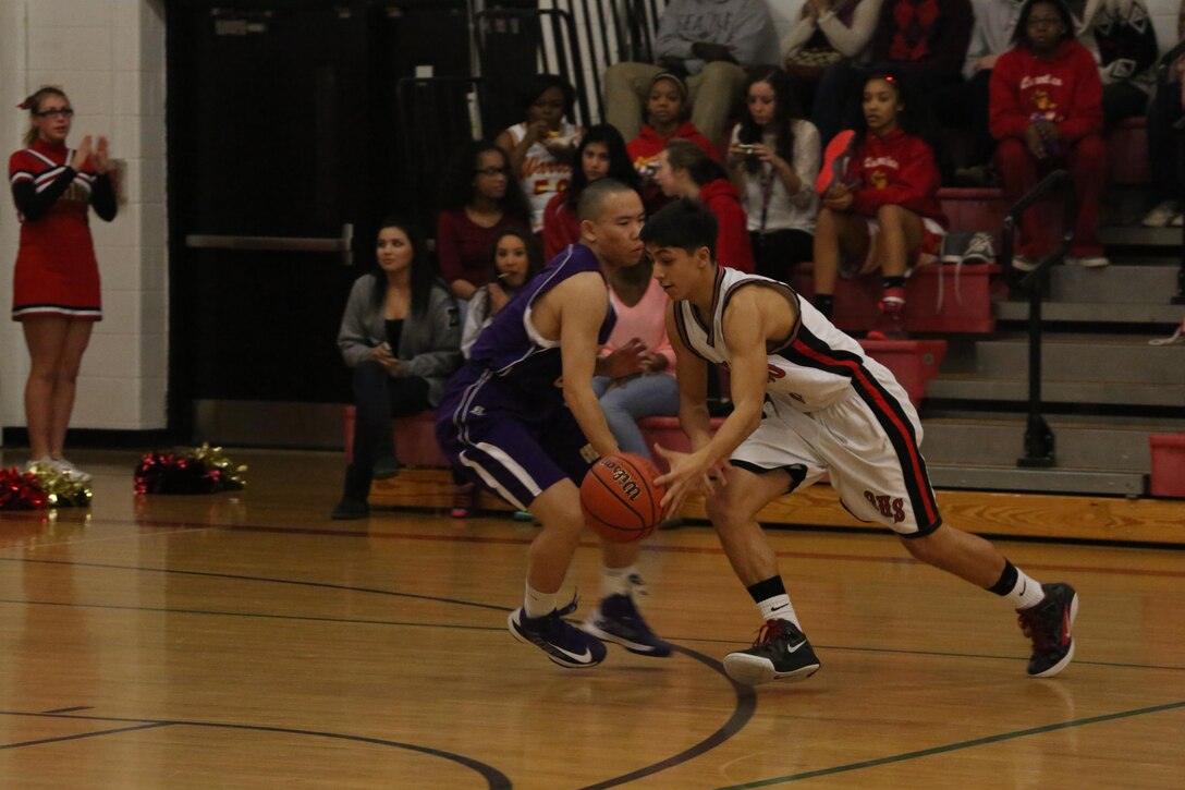 David, a sophomore at Quantico Middle/High School, drives past a player for the Massanutten Military Academy Colonels of Woodstock, during a home game on Feb. 7, 2014. The Quantico Warriors played hard the whole game but lost 59-52.