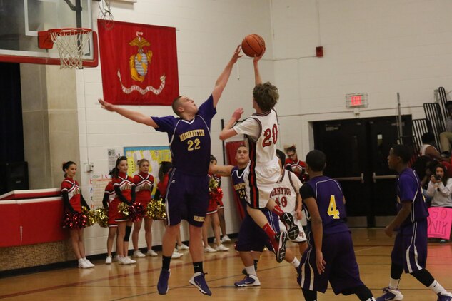 Chandler, number 20 and a junior at Quantico Middle/High School, takes a jump shot in a home game against Massanutten Military Academy Colonels of Woodstock, on Feb. 7, 2014. The Quantico Warriors fought hard the whole game, but weren’t able to hold back the Colonels and lost 59-52.