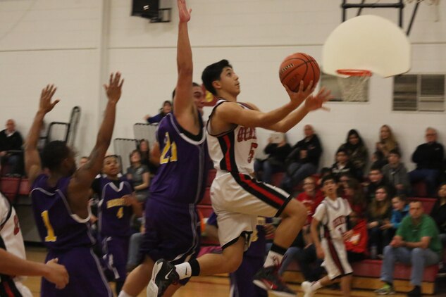 David, a sophomore at Quantico Middle/High School, drives to the basket against Massanutten Military Academy Colonels of Woodstock, during a home game on Feb. 7, 2014. The Quantico Warriors played hard the whole game but couldn’t hold on and lost 59-52.