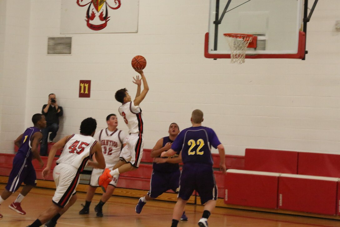 Naiko, number 3 and a sophomore for the Quantico Middle/High School Warriors, takes a jump shot during a home game against the Massanutten Military Academy Colonels of Woodstock, on Feb. 7, 2014. Naiko led the Warriors in scoring with 17 points, but despite his efforts they lost 59-52.