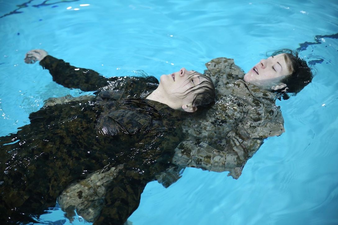 Second Lt. Sara Shannon, a student at The Basic School, practices a double armpit tow rescue on Seaman Rebecca Ward, a corpsman with The Basic School, at Ramer Hall on Feb. 4, 2014. They were participating in Water Survival Advanced.
