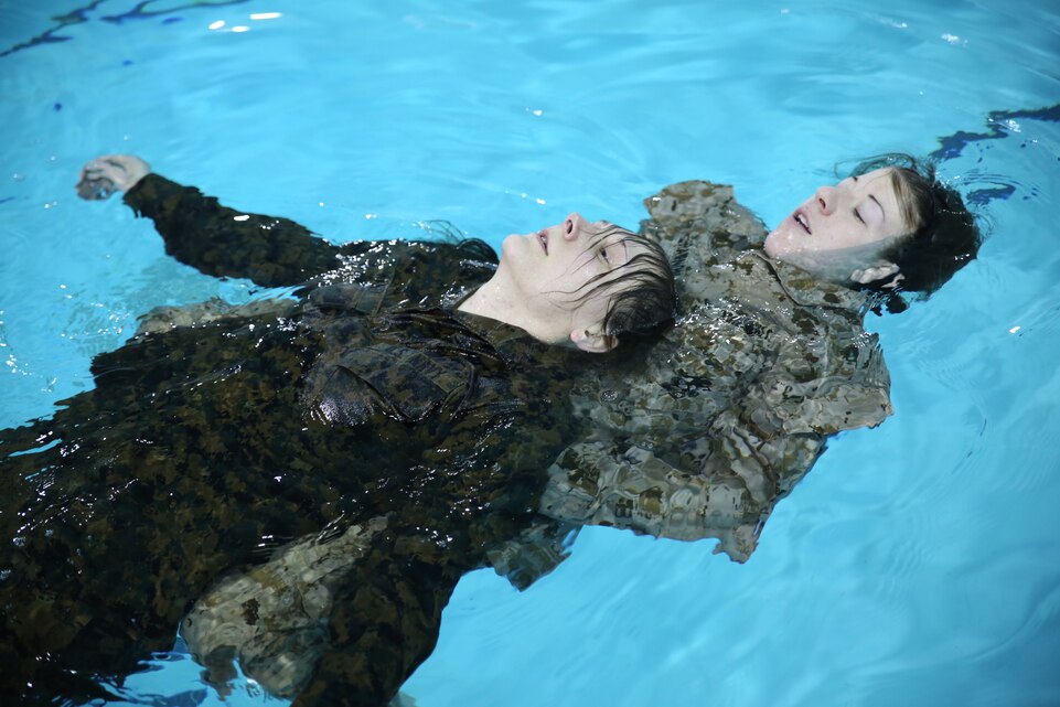 Second Lt. Sara Shannon, a student at The Basic School, practices a double armpit tow rescue on Seaman Rebecca Ward, a corpsman with The Basic School, at Ramer Hall on Feb. 4, 2014. They were participating in Water Survival Advanced.