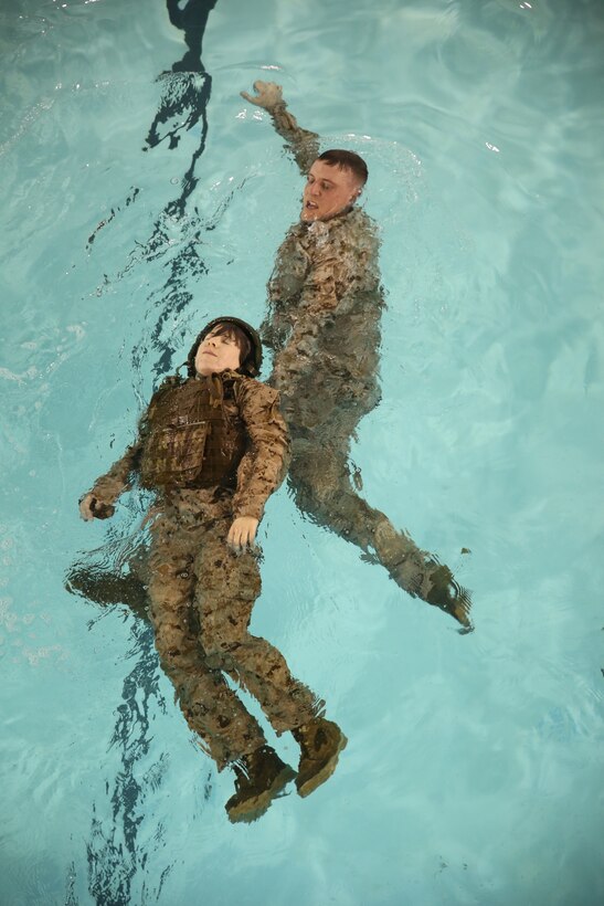 Staff Sgt. Charles Martin, an infantry unit leader with The Basic School, practices a single armpit tow on 2nd Lt. Sara Shannon, a student at The Basic School, at Ramer Hall on Feb. 5, 2014. They were performing this exercise as a portion of Water Survival Advance qualification course.