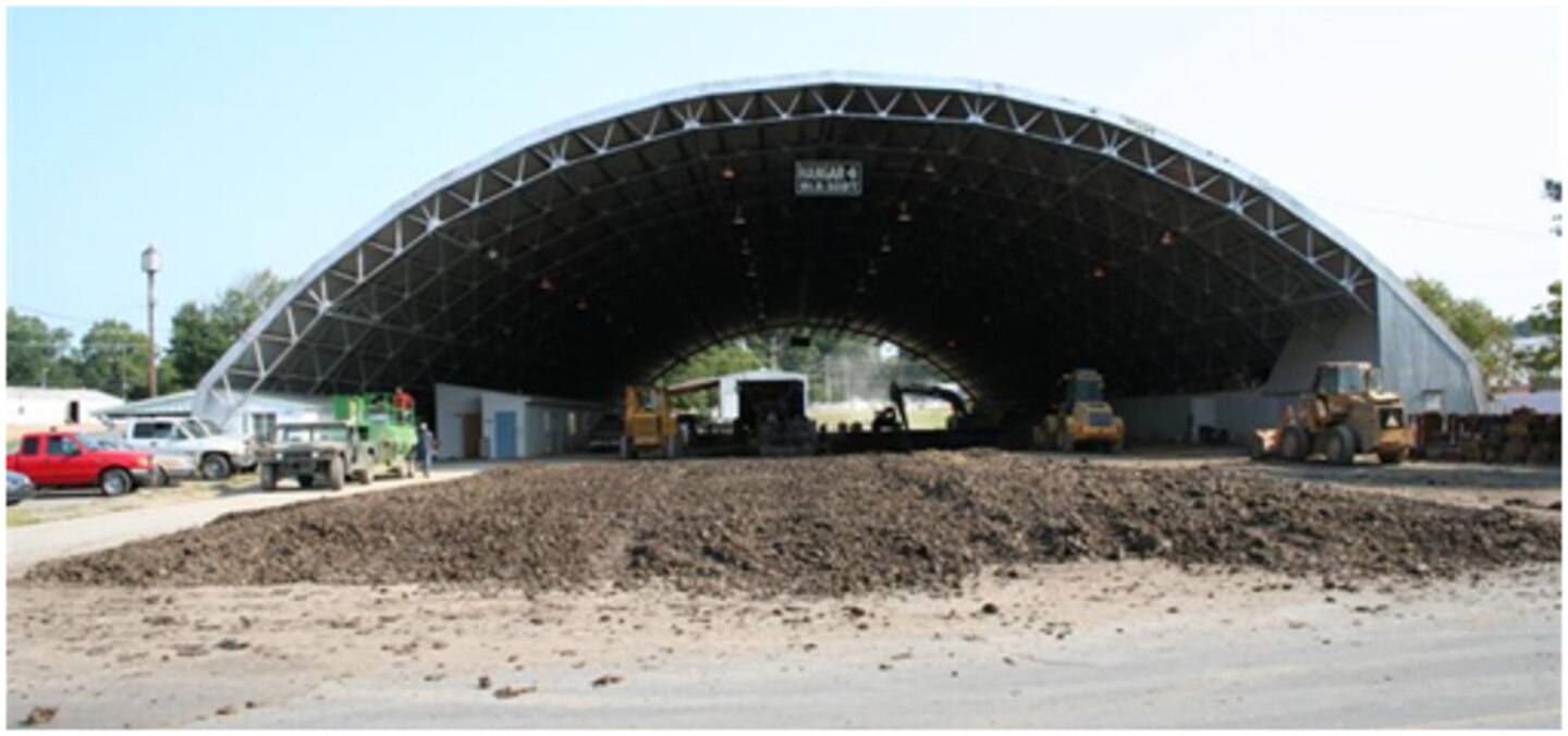 Buckshot clay for low-strength test section construction dries in the foreground of this ground-level view of the ERDC Pavement Testing Facility.