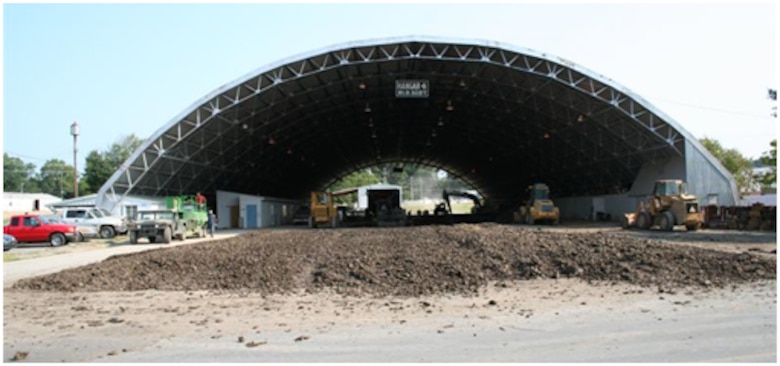 Buckshot clay for low-strength test section construction dries in the foreground of this ground-level view of the ERDC Pavement Testing Facility.