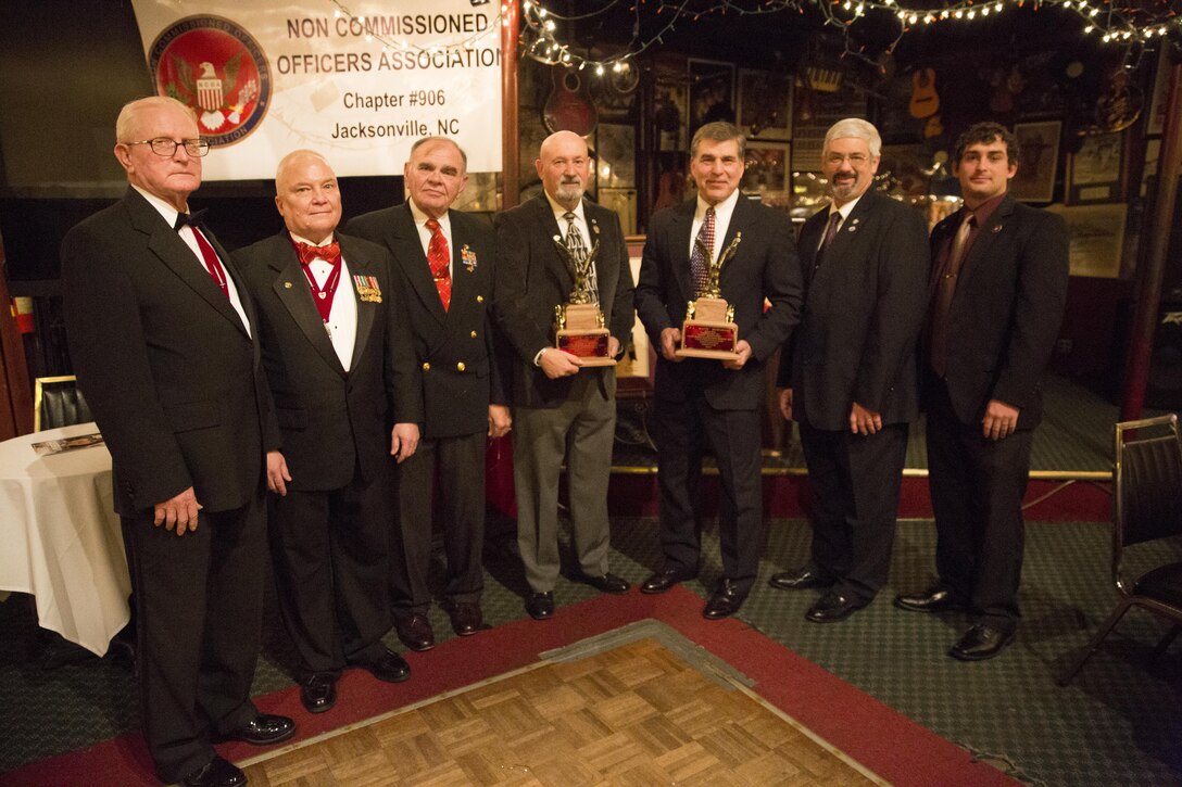 Members of the Noncommissioned Officers Association stand next to the recipients of the the Sergeant Major C.A. “Mack” McKinney Award during the annual ceremony at Sywanyk’s Scarlet and Gold Traditions in Jacksonville, N.C., Feb. 7. Service members, retirees and families gathered at the event to support those who were awarded.