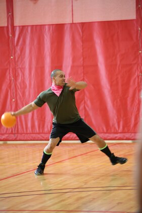 Cpl. Christopher Cox, an administrative clerk for Manpower Management Military Awards, Manpower Management Support Branch, prepares to throw a ball at the opposing team at Barber Physical Activity Center on Feb. 7, 2014. Cox was participating in the Headquarters and Service Battalion Quarterly Dodge Ball Tournament.