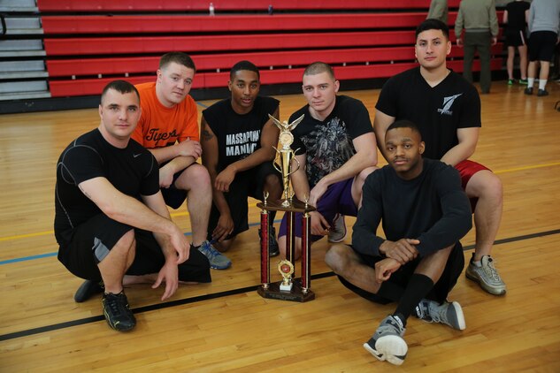 Cpl. Taylor Sams, Cpl. Daniel Quigley, Cpl. Freddie Richardson, Cpl. Alex Washington, Cpl. Max Hernandez and Cpl. Nardarius Durr, all finance Technicians for Combat Development Company, pose with the first place trophy at Barber Physical Activity Center on Feb. 7, 2014. They were undefeated and won with a record of 6-0 at the Headquarters and Service Battalion Quarterly Dodge Ball Tournament.