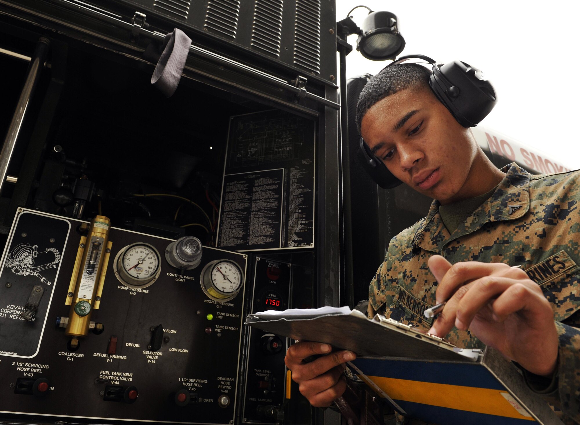 Marine Corps Lance Cpl. Derrick Wilkerson logs a consolidation sheet during a field exchange program Feb. 6, 2014, at Kadena Air Base, Japan. The 18th Logistics Readiness Squadron provided training to Marines to teach bulk refueling techniques, lab analysis and issuance of aviation fuels. Wilkerson is a 9th Engineer Support Battalion bulk fuel technician. (U.S. Air Force photo/Naoto Anazawa)