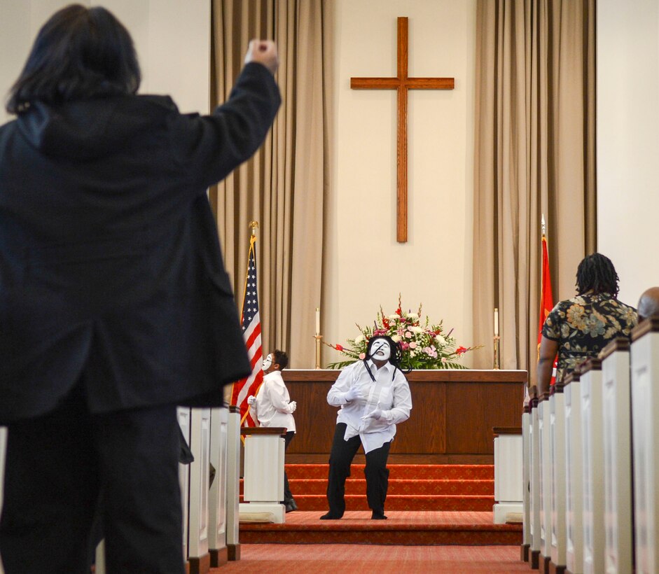Brandi Bacte, a member of the Manassas Life Church Young Adult Mimes, performs an interprative dance while a praise chorus plays at the Marine Memorial Chapel aboard Marine Corps Base Quantico during the 20th Annual Gospel Sing on Feb. 8, 2014.
