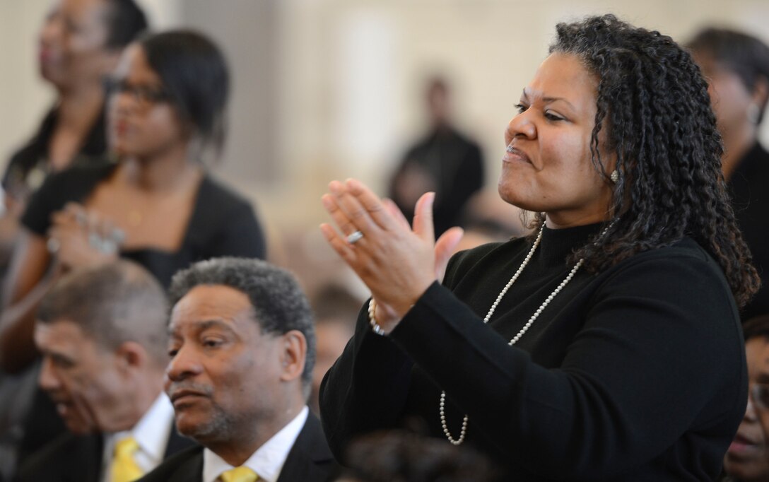 Tonie Jones, a Dale City, resident, stands and applauds performers at the Marine Memorial Chapel aboard Marine Corps Base Quantico during the 20th Annual Gospel Sing on Feb. 8, 2014. Many of the men and women present had attended the previous five years and said they wouldn't miss the next five.