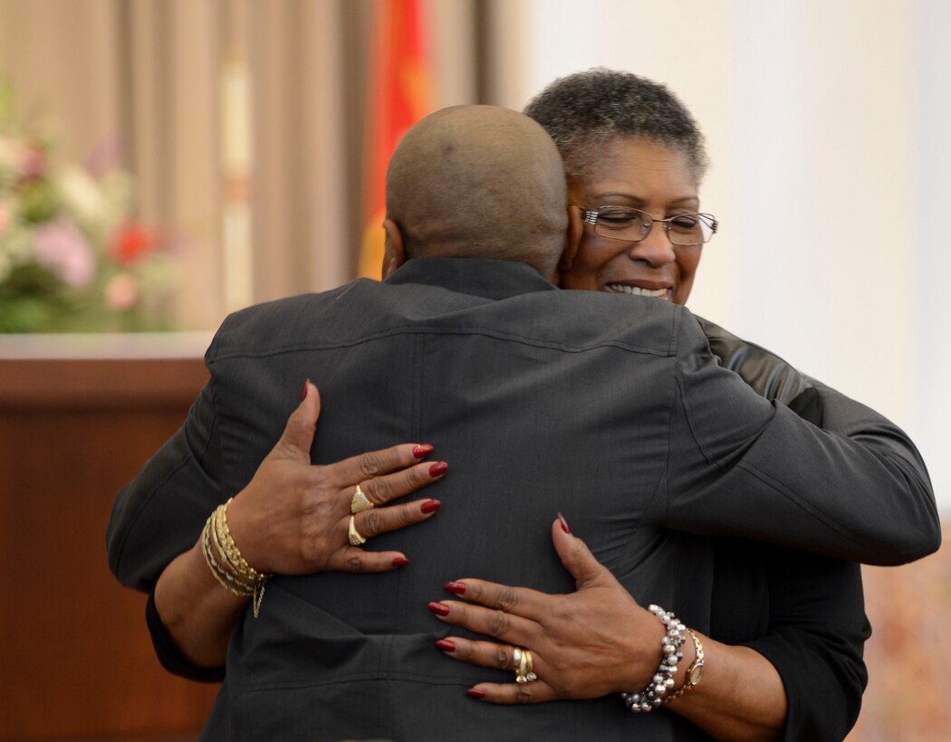 Demetria Thomas embraces Eric Richards, the creator of the base gospel sing at the Marine Memorial Chapel aboard Marine Corps Base Quantico during the 20th Annual Gospel Sing on Feb. 8, 2014.
