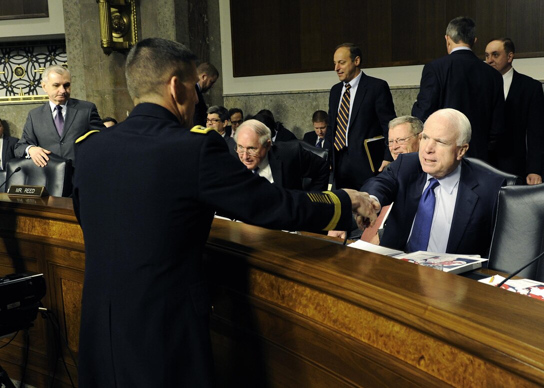 DIA Director Army Lt. Gen. Michael Flynn is greeted by Sen. John McCain prior to testifying before the Senate Armed Forces Committee Feb. 11. Photos by DIA Public Affairs