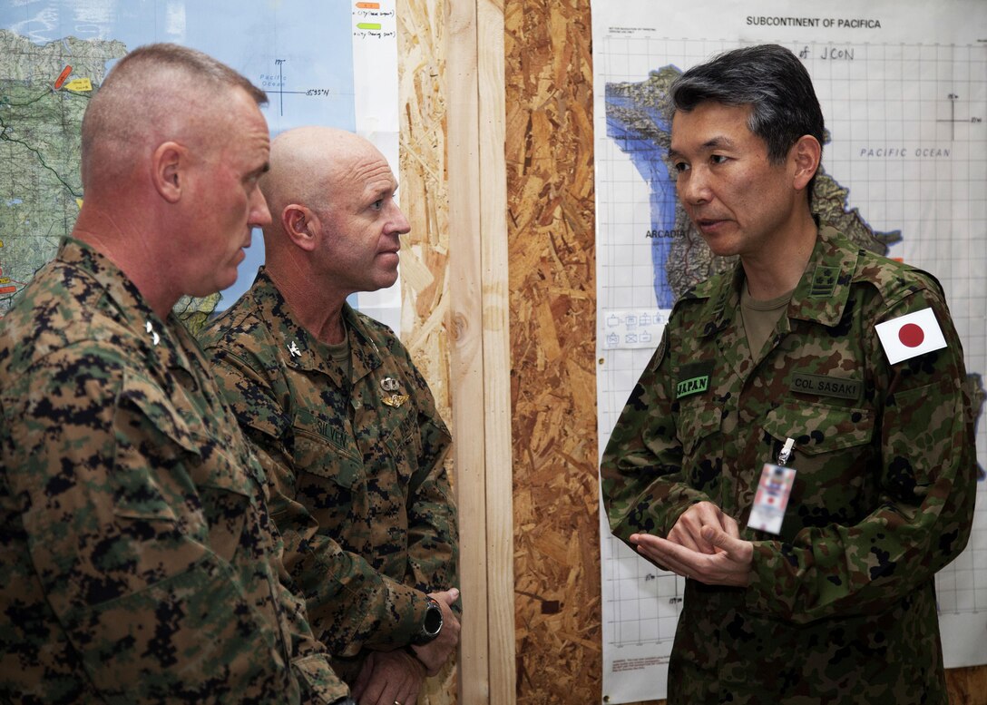 U.S. Marine Maj. Gen. H. Stacy Clardy III and Col. Michael Silven speak to Japan Self-Defense Forces Col. Sasaki after the opening ceremony of Exercise Cobra Gold 2014 on Camp Akatosarot, Phitsanulok, Kingdom of Thailand. CG 14, in its 33rd iteration, demonstrates the U.S. and the Kingdom of Thailand's commitment to their long-standing alliance and regional partnership, prosperity and security in the Asia-Pacific region. Clardy is the commanding general for 3rd Marine Division, III Marine Expeditionary Force. Silven is the director of information operations, U.S. Marine Corps Forces, Pacific.
