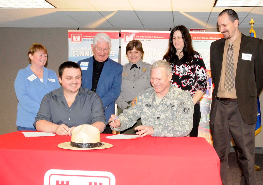 Don Kelly (left), president of Tioga-Hammond and Cowanesque Lakes officially signs the cooperative agreement with U.S. Army Corps of Engineers Baltimore District commander Col. Trey Jordan along with members from the board.