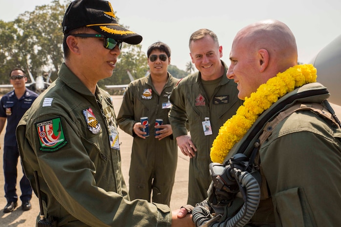 Group Captain Narong Intachat, left, welcomes Capt. Timothy Barchett to Wing One Royal Thai Air Force Base, Nakhon Ratchasima, Kingdom of Thailand, as part of a welcoming ceremony Feb. 2 during exercise Cobra Gold 2014. CG 14 is a joint, multinational exercise conducted annually in the Kingdom of Thailand to increase readiness and interoperability of the Thai, U.S. and other fully participating military forces. Intachat is the commander of Wing One, Royal Thai Air Force. Barchett is a pilot with Marine Fighter Attack Squadron 232, currently assigned to Marine Aircraft Group 12, 1st Marine Aircraft Wing, III Marine Expeditionary Force under the unit deployment program. (U.S. Marine Corps photo by Cpl. James R. Smith/released)


