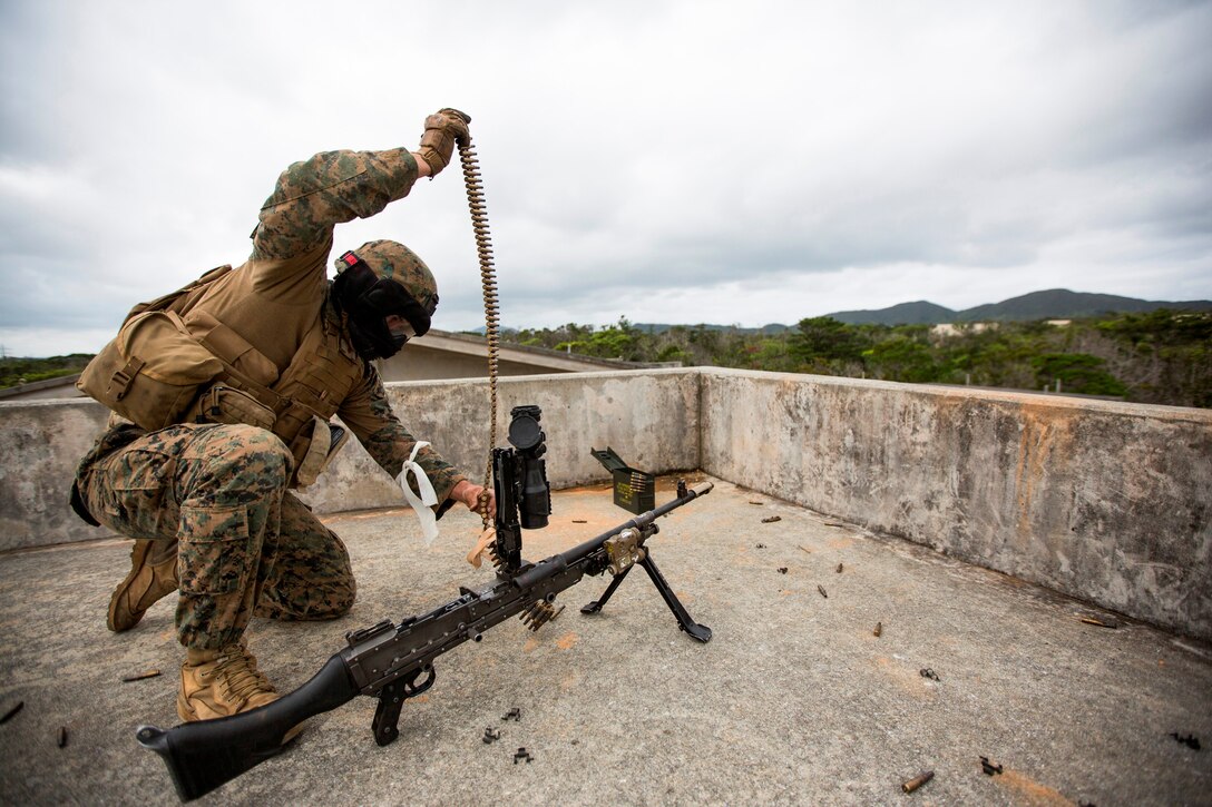 Lance Cpl. Wesley Rhea, a machine gunner with Weapons Company, Battalion Landing Team 2nd Battalion, 5th Marines, 31st Marine Expeditionary Unit, and a native of Oklahoma City, Okla., reloads a M240G medium machine gun during urban combat training here, Feb 8. The Marines utilized Special Effects Small Arms Marking System (SESAMS) rounds and a Military Operation on Urban Terrain facility to simulate actual combat. The 31st MEU is the Marine Corps’ force in readiness in the Asia-Pacific region and is the only continuously forward-deployed MEU. 