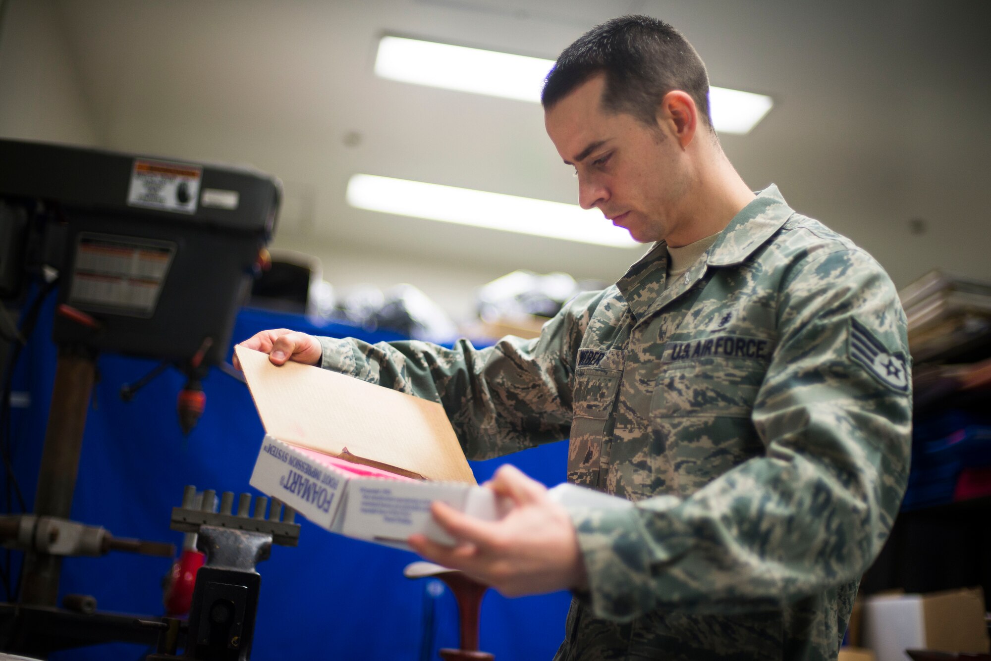 Staff Sgt. Russell Weber, 374th Surgical Operations Squadron NCOIC of Orthotics, analyzes a foot mold prior to creating shoe inserts at Yokota Air Base, Japan, Feb. 12, 2014. Weber spends the majority of his time creating shoe inserts for several local bases due to limited Orthotics specialists. (U.S. Air Force photo by Staff Sgt. Chad C. Strohmeyer/Released)