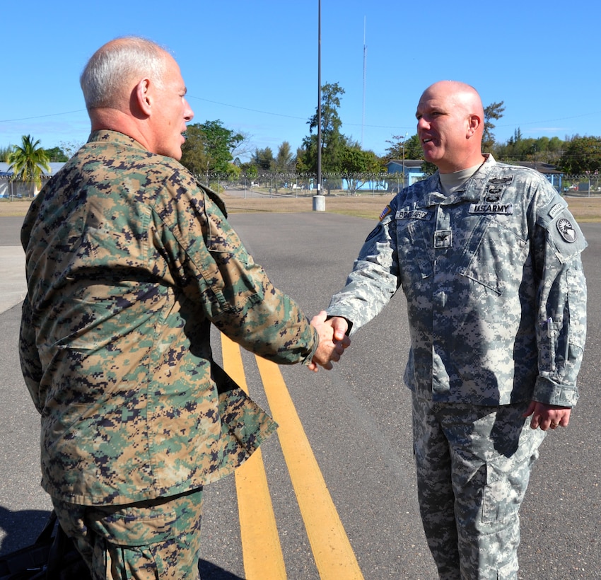 U.S. Army Col. Thomas Boccardi, Joint Task Force-Bravo Commander, greets U.S. Marine Corps Gen. John F. Kelly, Commander, U.S. Southern Command, on the flightline at Soto Cano Air Base, Honduras, Feb. 11, 2014. Kelly is visiting Honduras during the week to meet with U.S. and Honduran military and civilian leaders within the country. (U.S. Air Force photo by Capt. Zach Anderson)