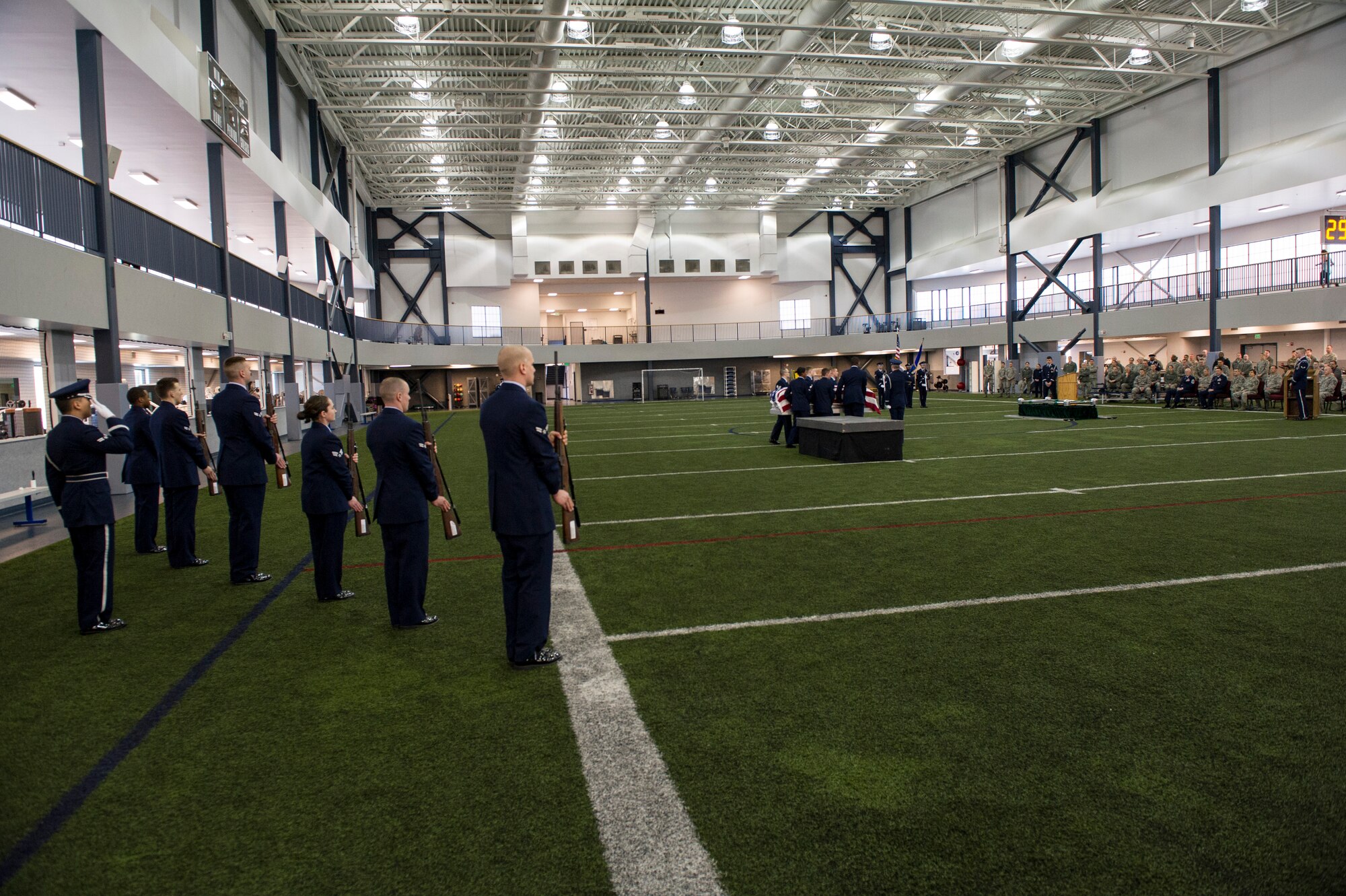 Members of the base honor guard team present arms during a mock military funeral with honors Feb. 7, 2014, Eielson Air Force Base, Alaska. Twelve new members completed 40 hours of training which included pall bearing, firing team, colors, proper wear of the ceremonial dress and the importance of military customs and courtesies. (U.S. Air Force photo by Senior Airman Joshua Turner/Released)