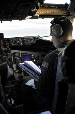 Maj. Jason Eddy, a 93rd Air Refueling Squadron KC-135 Stratotanker instructor pilot, begins a pre-flight check with other crew members before a training mission at Fairchild Air Force Base, Wash., Feb. 6, 2014. Pre-flight checks are done with the help of a ground crew to ensure the aircraft is mission-ready. (U.S. Air Force photo/Senior Airman Mary O'Dell)