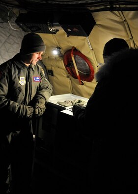 Maj. Jason Eddy, a 93rd Air Refueling Squadron KC-135 Stratotanker instructor pilot, begins a pre-flight check with other crew members before a training mission at Fairchild Air Force Base, Wash., Feb. 6, 2014. Pre-flight checks are done to ensure the aircraft is mission-ready. (U.S. Air Force photo/Senior Airman Mary O'Dell)