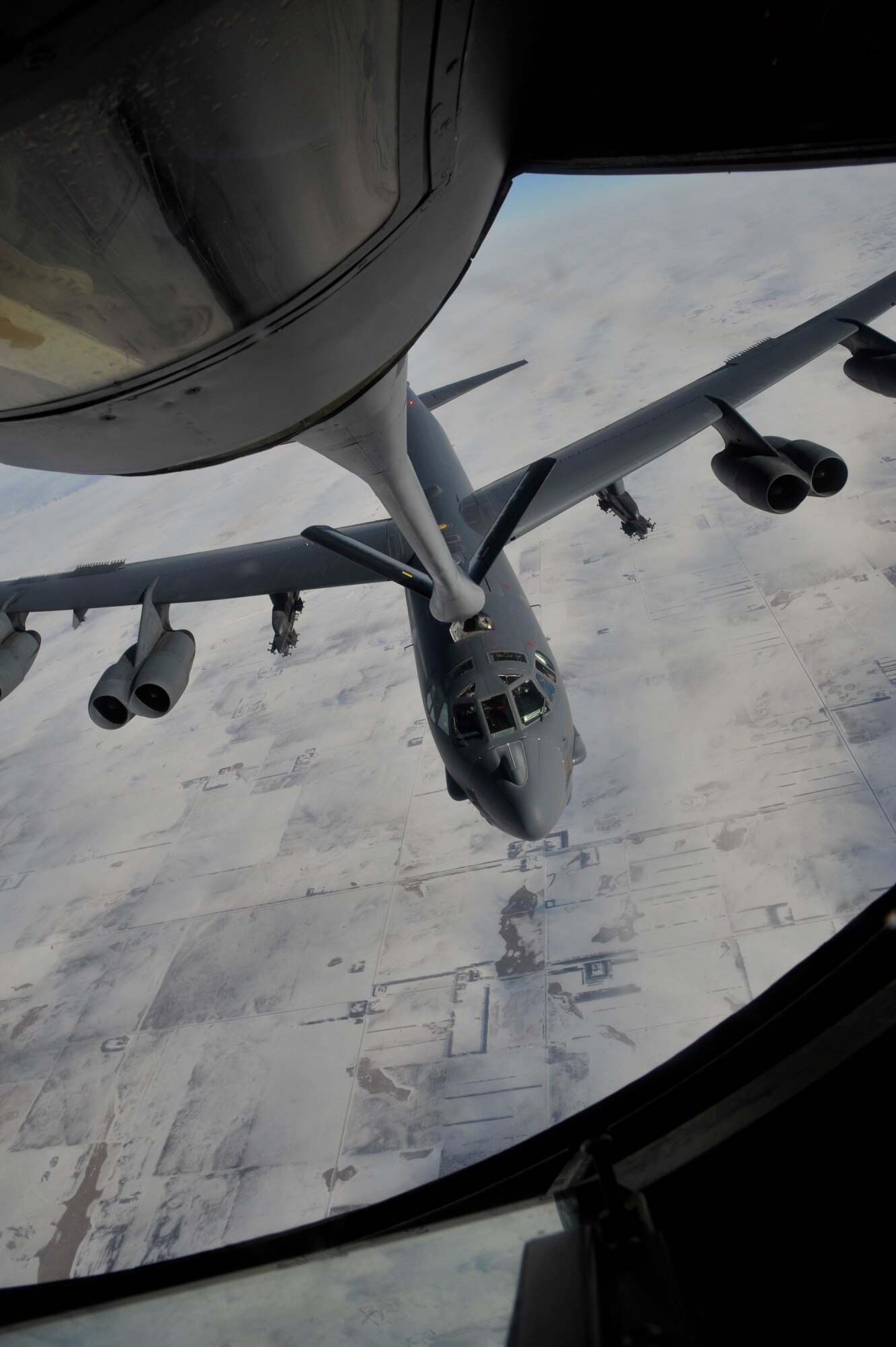 A B-52H Stratofortess, assigned to the 5th Bomb Wing at Minot Air Force Base, N.D., is refueled by a KC-135 Stratotanker from Fairchild Air Force Base, Wash., Feb. 6, 2014. Fairchild is home to more than 30 KC-135s and perform refueling missions world-wide. (U.S. Air Force photo by Senior Airman Mary O'Dell/Released)