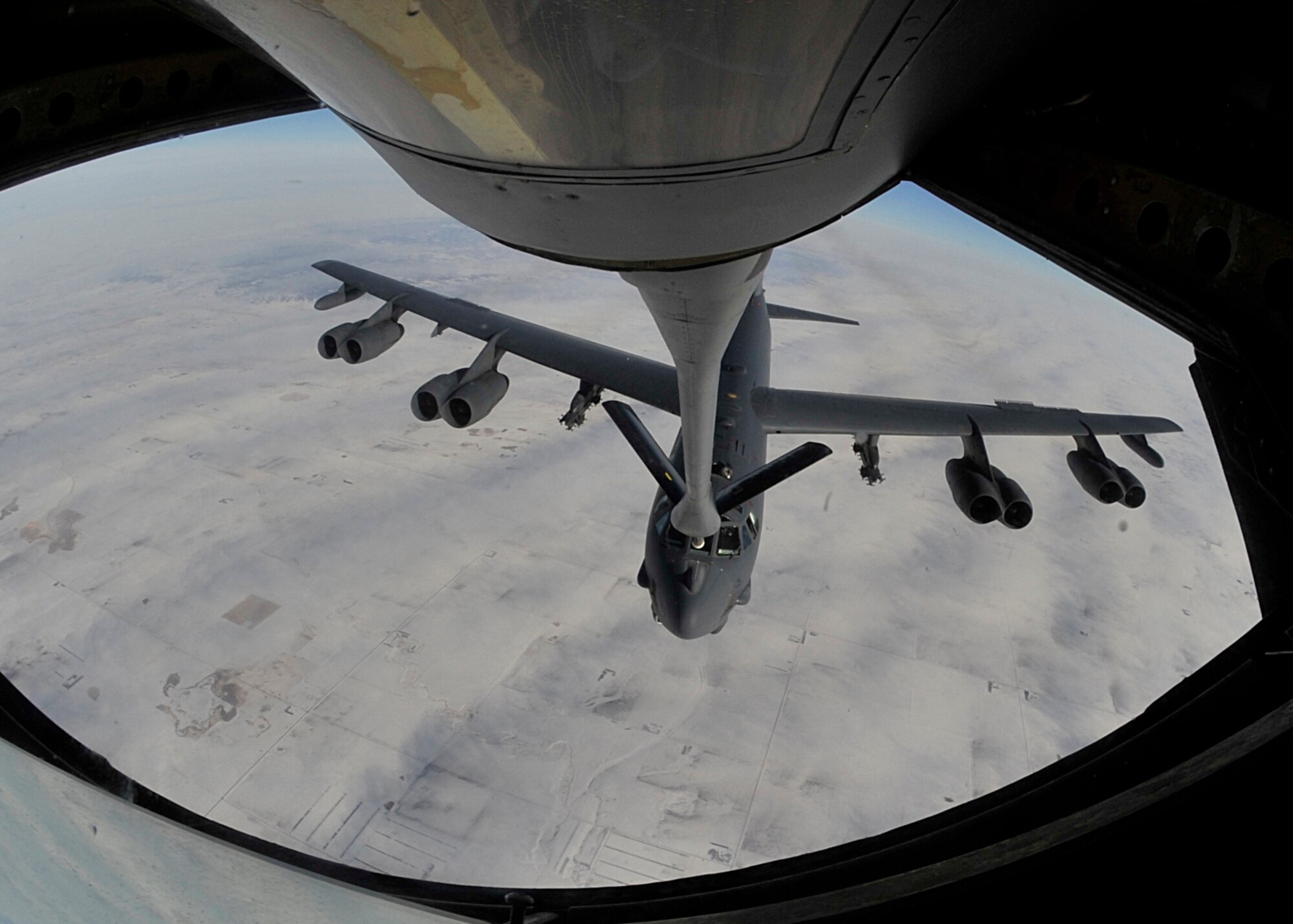 A B-52H Stratofortess, assigned to the 5th Bomb Wing at Minot Air Force Base, N.D., is refueled by a KC-135 Stratotanker from the 92nd Air Refueling Wing at Fairchild Air Force Base, Wash., Feb. 6, 2014. The KC-135 can transfer up to 200,000 pounds of fuel and can carry up to 83,000 pounds of cargo. (U.S. Air Force photo by Senior Airman Mary O'Dell/Released)