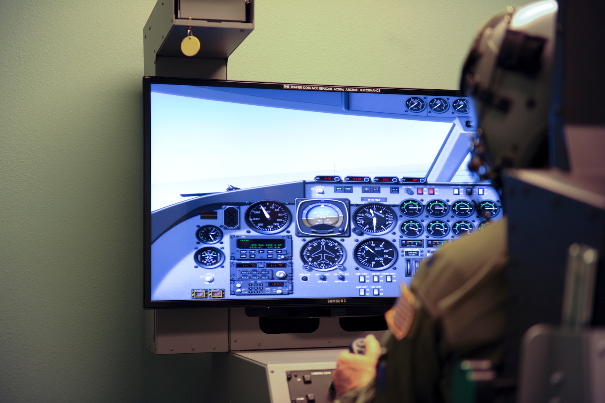 Lt. Col. Ty Piercefield, 53rd Weather Reconnaissance Squadron pilot, who is stationed at Keesler Air Force Base, Miss., flies an aircraft simulator during refresher physiological hypoxia training at Hurlburt Field, Fla., Feb. 4, 2014. Unlike normal altitude chambers, the reduced oxygen breathing device allowed Piercefield to perform in-flight procedures during the training. (U.S. Air Force photo/Airman 1st Class Jeff Parkinson)