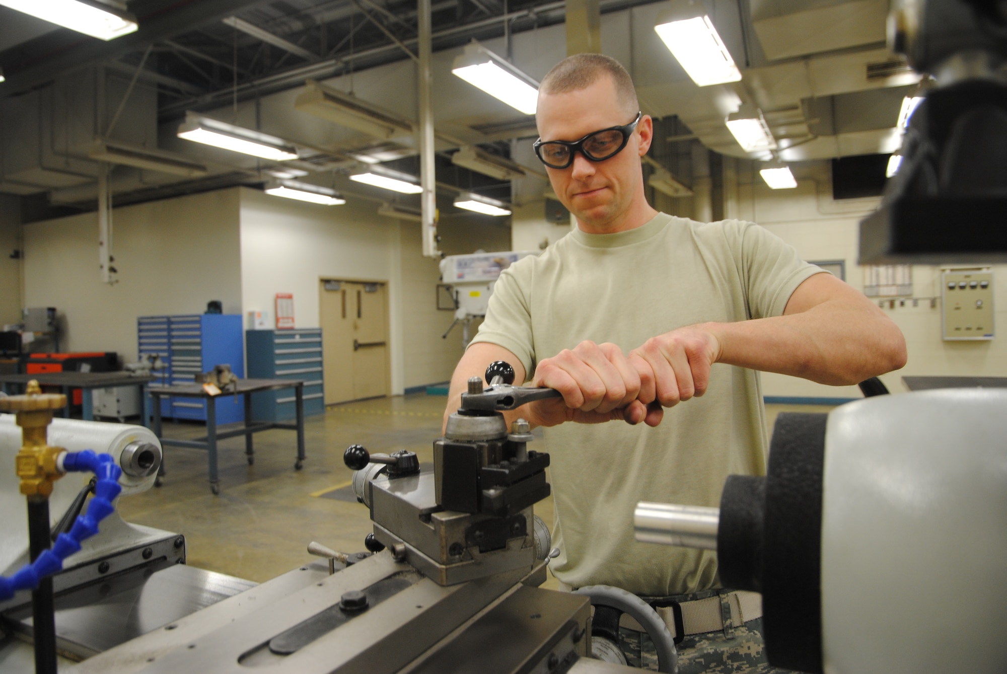 Staff Sgt. Edward James Broz, 69th Maintenance Squadron aircraft metals technology craftsman, uses a wrench to tighten a nut on a metal lathe Feb. 7, 2014, at the 69th MXS workshop on Grand Forks Air Force Base, N.D. The 28-year-old Airman from Lake Worth, Fla., is the base’s Warrior of the Week for the second week of February 2014. (U.S. Air Force photo/Staff Sgt. Luis Loza Gutierrez) 
