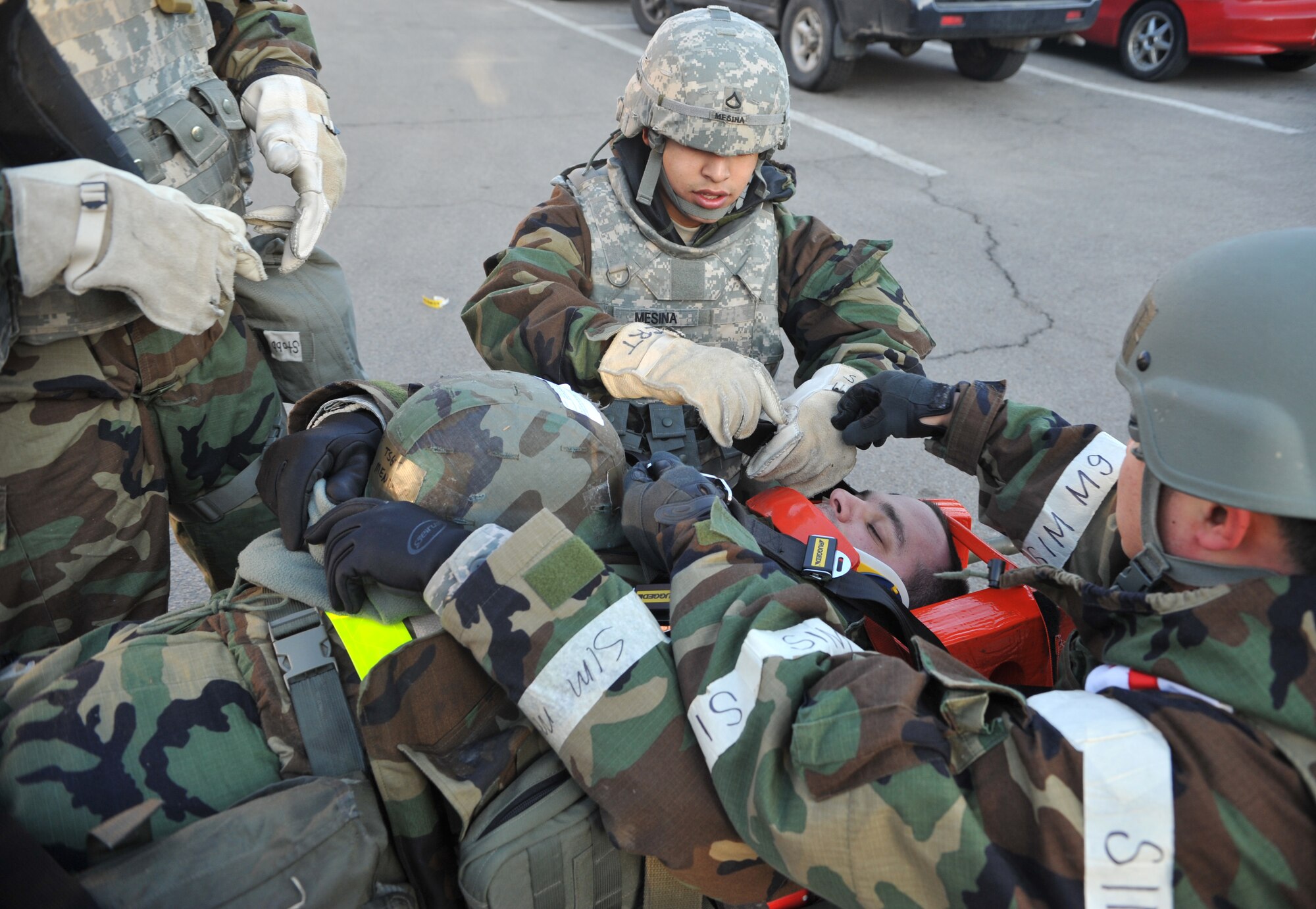 Members of the 51st Medical Group Field Response Team finish securing a mock casualty in a head immobilization apparatus as part of a mass casualty scenario outside Bldg. 938 during Operational Readiness Exercise Beverly Midnight 14-02 at Osan Air Base, Republic of Korea, Feb. 11, 2014. The 51st Comptroller Squadron post-attack reconnaissance team performed self aid and buddy care on 11 role players before the arrival of the FRT. (U.S. Air Force photo/Airman 1st Class Ashley J. Thum)