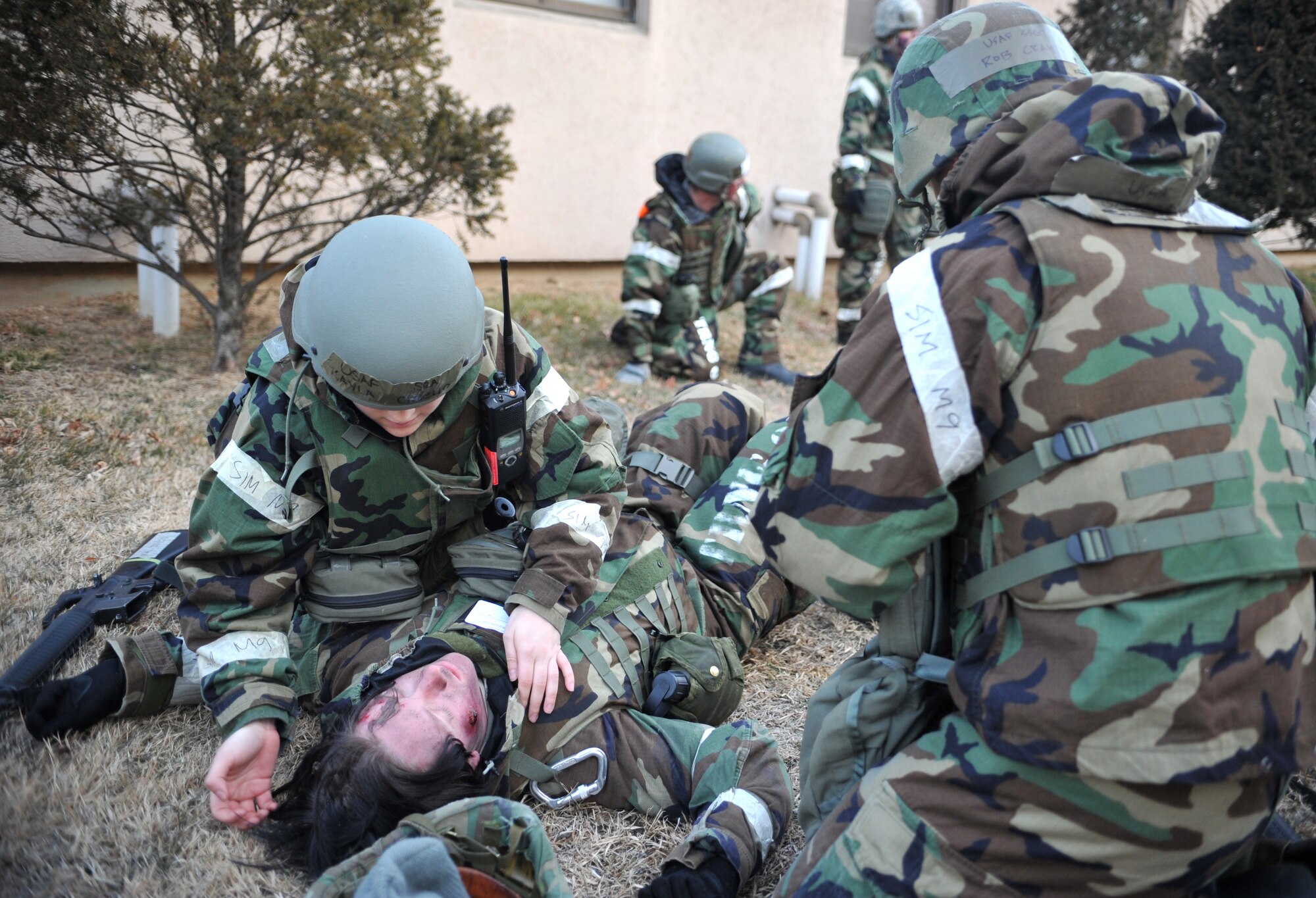 Members of the 51st Comptroller Squadron post-attack reconnaissance team assess a mock casualty’s injuries as part of a mass casualty scenario outside Bldg. 938 during Operational Readiness Exercise Beverly Midnight 14-02 at Osan Air Base, Republic of Korea, Feb. 11, 2014. Role players portrayed everything from lacerations and surface burns to hearing loss and an altered mental status. (U.S. Air Force photo/Airman 1st Class Ashley J. Thum)